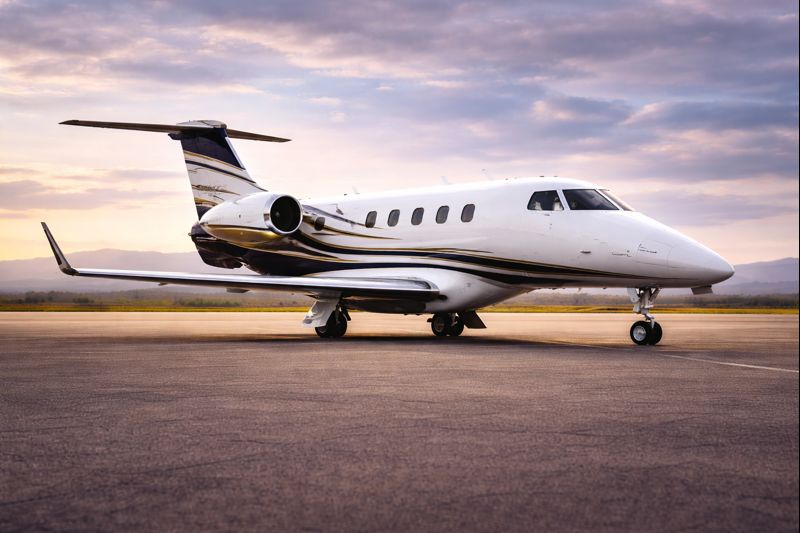 Embraer Phenom 300 private jet at sunset